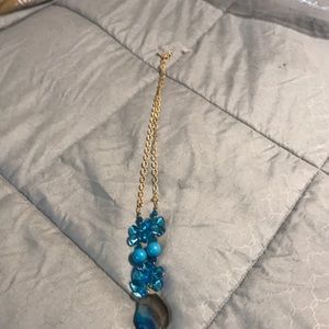 Gold tone necklace with stones